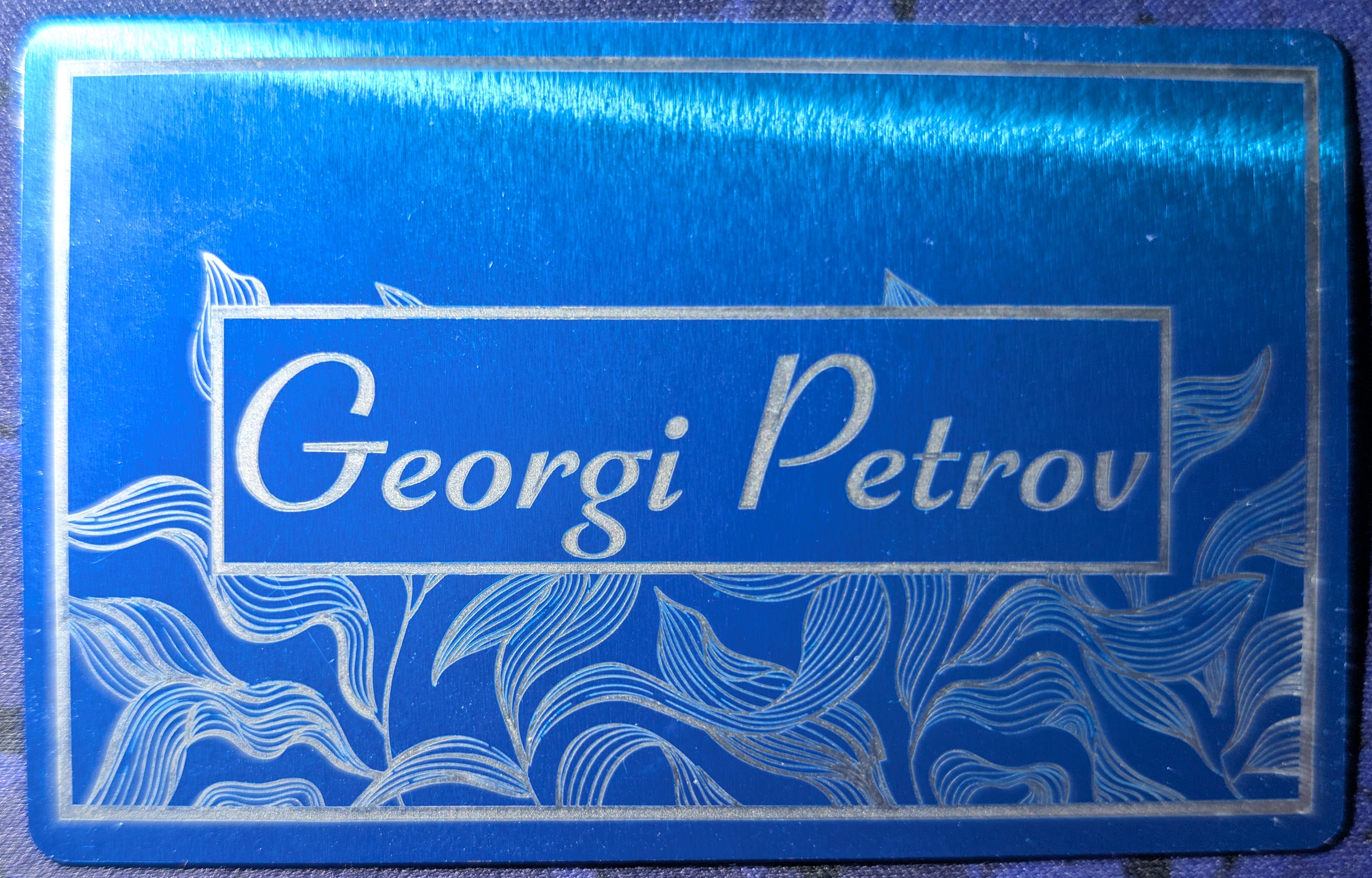 Blue annodized aluminum card with a QR code on the back
